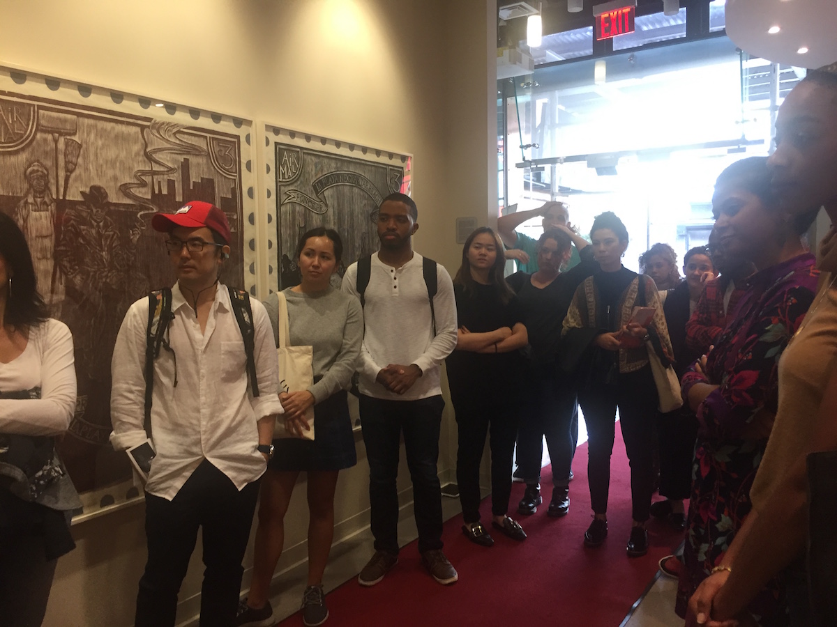 People gathered along the walls in a hall